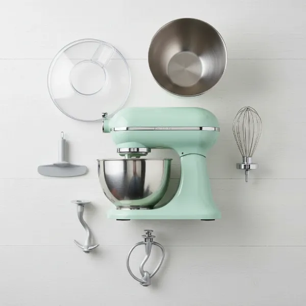 Frigidaire retro stand mixer with its accessories: flat beater, dough hook, wire whisk, and splash guard.