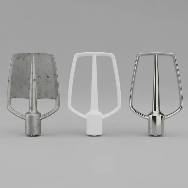 Three different stand mixer beaters: burnished aluminum, coated, and stainless steel.