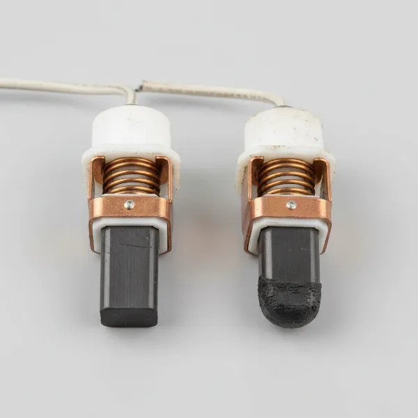 Side-by-side comparison of a new carbon brush and a significantly worn carbon brush for a stand mixer.